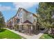 Attractive multi-story townhome featuring stone accents and well-maintained landscaping under a blue sky at 12711 Colorado Blvd # 1009, Thornton, CO 80241