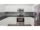 Modern kitchen with stainless steel appliances, ample cabinetry, and stylish backsplash at 12711 Colorado Blvd # 1009, Thornton, CO 80241