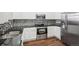 Modern kitchen featuring stainless steel appliances, a mosaic tile backsplash, and white cabinetry at 12711 Colorado Blvd # 1009, Thornton, CO 80241