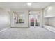 Bright and spacious living area with large windows, carpet flooring, and balcony access at 12711 Colorado Blvd # 1009, Thornton, CO 80241