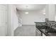 View of the living room with stainless steel kitchen appliances and staircase in an open floor plan at 12711 Colorado Blvd # 1009, Thornton, CO 80241