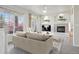 Bright living room with large windows, neutral decor, fireplace, and stylish furnishings at 12711 Colorado Blvd # 1009, Thornton, CO 80241