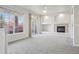 Light-filled living room with a cozy fireplace and access to an outdoor balcony at 12711 Colorado Blvd # 1009, Thornton, CO 80241