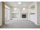 Open-concept living area with neutral paint, plush carpet, and access to the outdoor patio at 12711 Colorado Blvd # 1009, Thornton, CO 80241