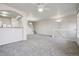 Bright, open-concept living room with gray carpeting and an adjacent staircase at 12711 Colorado Blvd # 1009, Thornton, CO 80241