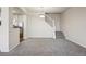 Neutral living room with grey carpet and an adjacent staircase at 12711 Colorado Blvd # 1009, Thornton, CO 80241
