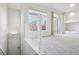 Bright living room features plush carpets, large windows, and seamless flow to a balcony with natural light at 12711 Colorado Blvd # 1009, Thornton, CO 80241