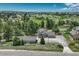 Expansive aerial view of a home surrounded by lush trees and greenery in a beautiful neighborhood at 10534 Inspiration Dr, Parker, CO 80138