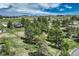 Expansive aerial view of a home nestled amongst mature trees in a serene, sprawling landscape at 10534 Inspiration Dr, Parker, CO 80138