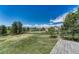 Vast backyard with mature trees, open space and blue skies at 10534 Inspiration Dr, Parker, CO 80138