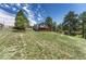 View of the back of the house, featuring a wooden deck with a grassy lawn at 10534 Inspiration Dr, Parker, CO 80138