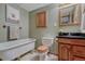 Bathroom offers a clawfoot tub, tile floors, and rustic vanity at 10534 Inspiration Dr, Parker, CO 80138