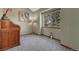 Cozy bedroom with neutral carpeting, natural light, and a quaint writing desk at 10534 Inspiration Dr, Parker, CO 80138