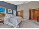 Bright bedroom features a ceiling fan, neutral carpet, and large closet at 10534 Inspiration Dr, Parker, CO 80138