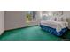 Bedroom features bright green carpet, a large window, and soft natural light at 10534 Inspiration Dr, Parker, CO 80138