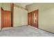 Carpeted bedroom with two doors and a closet with mirrored sliding doors at 10534 Inspiration Dr, Parker, CO 80138