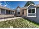 Charming home exterior featuring brick and gray siding, large windows, and manicured lawn at 10534 Inspiration Dr, Parker, CO 80138