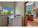 Convenient laundry area with a modern washer, bright window, and seamless access to the kitchen at 10534 Inspiration Dr, Parker, CO 80138