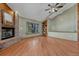 Inviting living room featuring a brick fireplace, built-in shelves, and a large window for natural light at 10534 Inspiration Dr, Parker, CO 80138