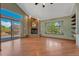 Spacious living room features a brick fireplace, large windows, and hardwood floors at 10534 Inspiration Dr, Parker, CO 80138