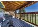 Covered patio with wood plank floor provides views of the treed landscape at 10534 Inspiration Dr, Parker, CO 80138