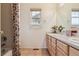 Bright bathroom features double sinks, tile floors, and a neutral color palette at 20875 E Girard Pl, Aurora, CO 80013