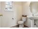 Charming half bath with pedestal sink, tile flooring, and a window bringing in light at 20875 E Girard Pl, Aurora, CO 80013