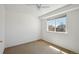 Bright bedroom with neutral carpet, ceiling fan and large window at 20875 E Girard Pl, Aurora, CO 80013