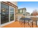Outdoor deck with table, chairs, and sliding glass door at 20875 E Girard Pl, Aurora, CO 80013
