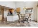 Bright dining area features tile floors and an elegant chandelier hanging above the table at 20875 E Girard Pl, Aurora, CO 80013