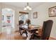 Formal dining room with hardwood floors, decorative lighting, and a charming window view at 20875 E Girard Pl, Aurora, CO 80013