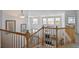 Open foyer showcasing natural wood railing, an overlooking view to below, and an abundance of natural light at 20875 E Girard Pl, Aurora, CO 80013