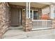 Close up shot of front door and covered porch with railing and steps at 20875 E Girard Pl, Aurora, CO 80013