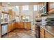 Open-concept kitchen with updated appliances, light wood cabinets, and breakfast bar at 20875 E Girard Pl, Aurora, CO 80013