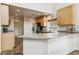 An open kitchen features light wood cabinets, stainless steel appliances, and neutral countertops at 20875 E Girard Pl, Aurora, CO 80013