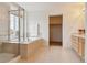 Bright main bathroom with a soaking tub, glass-enclosed shower, and large vanity at 20875 E Girard Pl, Aurora, CO 80013