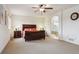 Spacious main bedroom featuring a large bed, bedside tables, and an arched doorway to the bathroom at 20875 E Girard Pl, Aurora, CO 80013