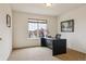 Comfortable office with a large window, neutral carpet, and a functional work space at 20875 E Girard Pl, Aurora, CO 80013
