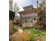 Two-story home featuring a quaint balcony and a beautiful backyard with blooming flowers at 780 N Lafayette St, Denver, CO 80218