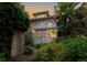 Exterior view of a backyard featuring a brick pathway, second story balcony, and lush landscaping at 780 N Lafayette St, Denver, CO 80218