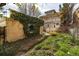 Backyard view features a two-story home and ivy-covered building connected by a brick walkway at 780 N Lafayette St, Denver, CO 80218