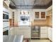 Elegant kitchen with stainless steel appliances, white cabinetry, and a window above the sink at 780 N Lafayette St, Denver, CO 80218