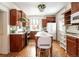 Traditional-style kitchen featuring hardwood floors, wood cabinets, an island and white appliances at 780 N Lafayette St, Denver, CO 80218