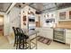 Charming kitchen featuring white cabinets, stainless steel appliances, and a tile ceiling at 780 N Lafayette St, Denver, CO 80218