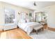 This main bedroom offers beautiful windows, hardwood floors, neutral decor, and a walk-in closet at 780 N Lafayette St, Denver, CO 80218