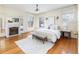 This spacious main bedroom features hardwood floors, a fireplace, and bright, stylish windows at 780 N Lafayette St, Denver, CO 80218