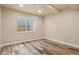 Finished basement bedroom with egress window and wood-look flooring at 12940 Jasmine St # A, Thornton, CO 80602