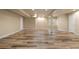 Large finished basement space with recessed lighting, neutral paint, and wood-look flooring at 12940 Jasmine St # A, Thornton, CO 80602