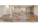 Finished basement area with wood-look flooring, neutral paint, and easy access to a bathroom at 12940 Jasmine St # A, Thornton, CO 80602