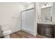 Bathroom featuring a glass-enclosed shower, wood-look flooring, and modern fixtures at 12940 Jasmine St # A, Thornton, CO 80602